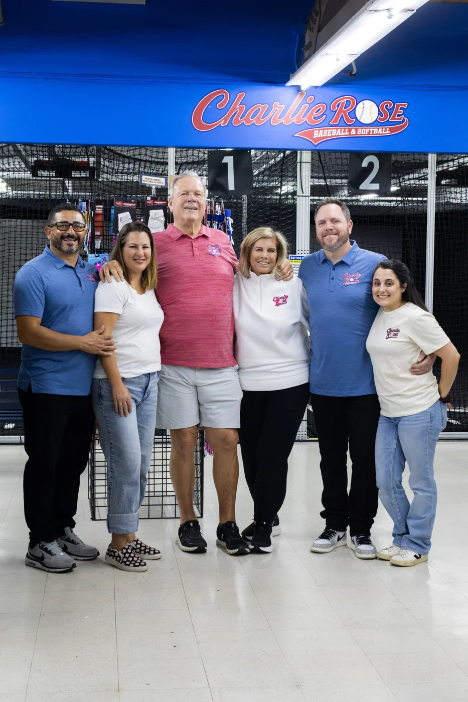 A group of adults posing inside the Charlie Rose shop